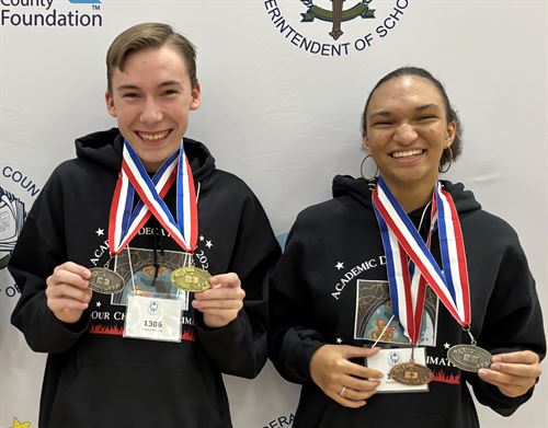 Picture of two high school students holding thier medals.