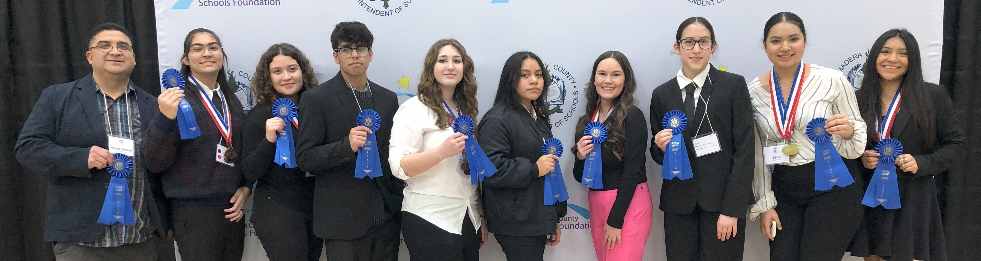 Picture of nine high school students with thier teachers holding ribbons.