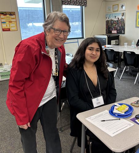 Picture of student and adult smiling.