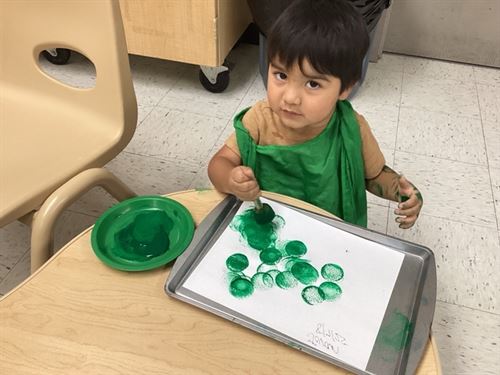 Picture of little boy fingerpainting.